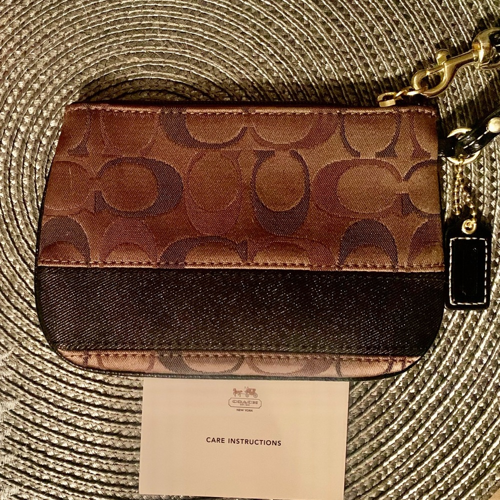 New Coach wristlet, never used, approximately      4.5”x6.5”